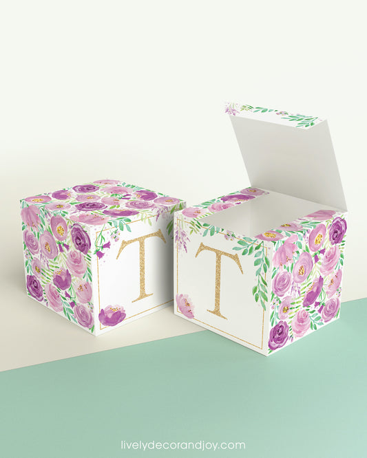 Two paper cubes with floral designs. One has the top open to show that the printable design can be used for blocks or boxes.