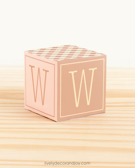 Letter block in cottagecore style with the letter W on the sides. It is made of paper.