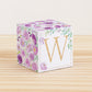 Letter block with printed boho floral designs and a gold letter W on the front. It is made of paper.