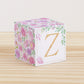 Block made of printed paper with watercolor flowers in blush and lavender. Has a peach letter Z on the front.