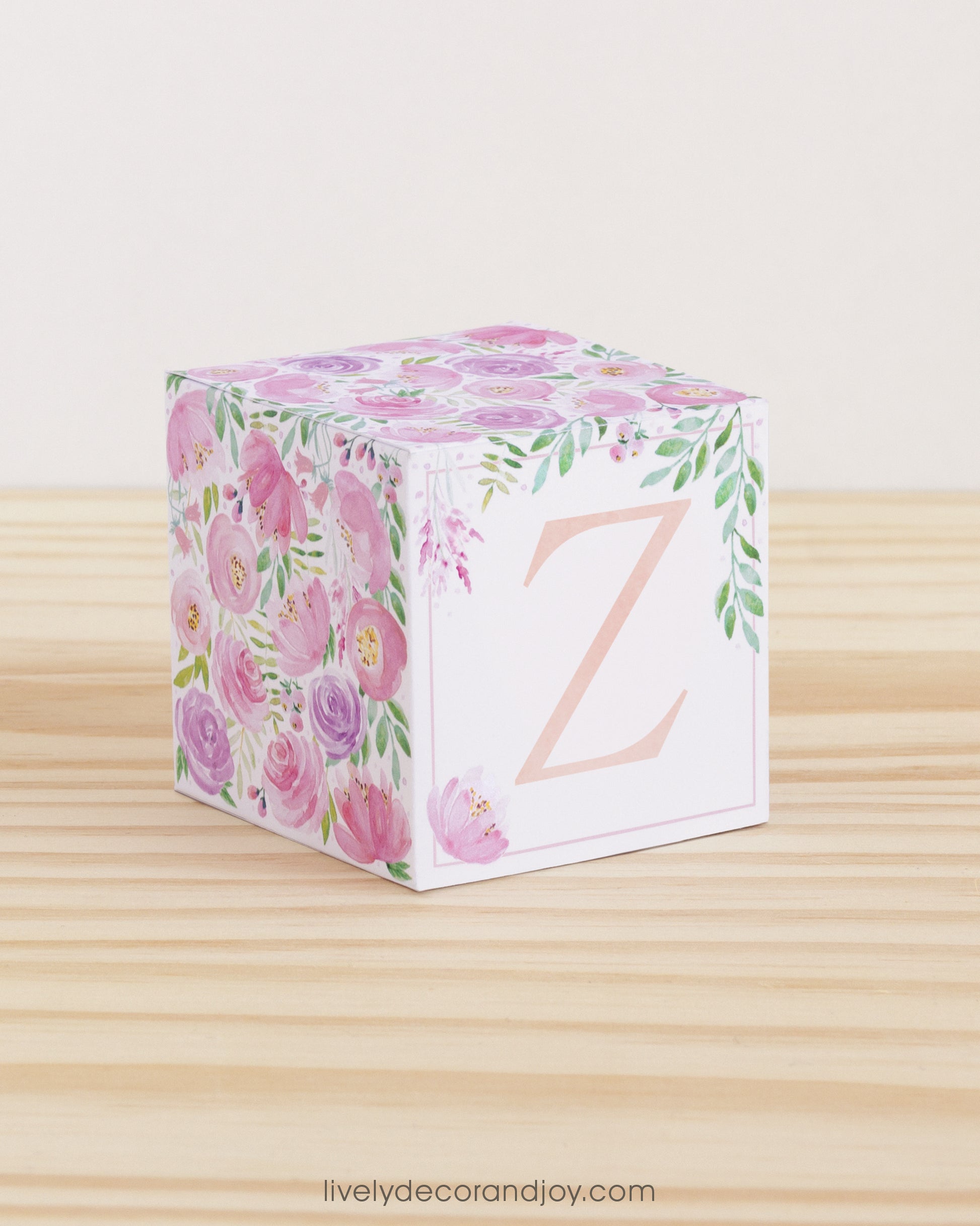 Block made of printed paper with watercolor flowers in blush and lavender. Has a peach letter Z on the front.