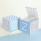 Two paper cubes with designs. One has the top open to show that the printable design can be used for blocks or boxes.