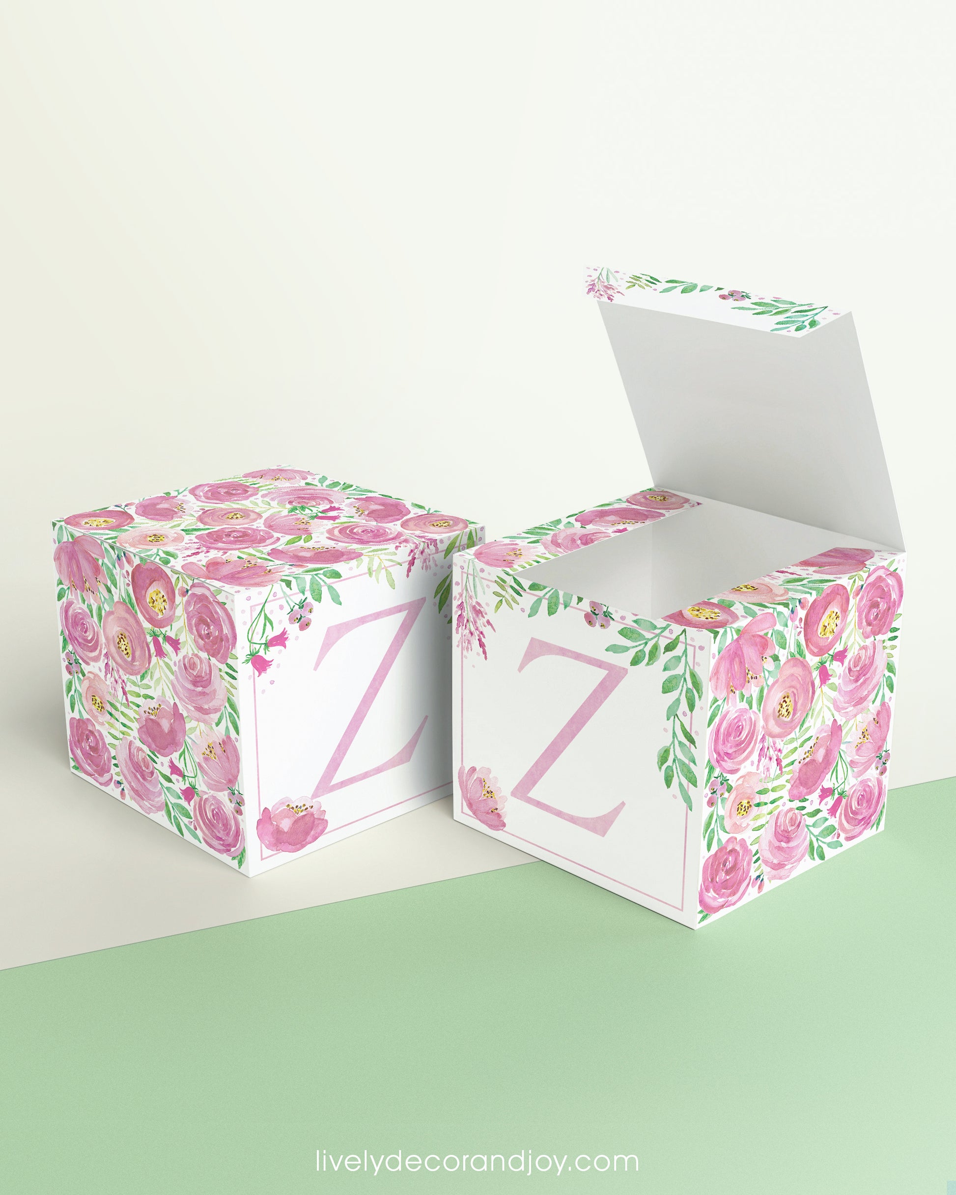 Two paper cubes with floral designs. One has the top open to show that the printable design can be used for blocks or boxes.