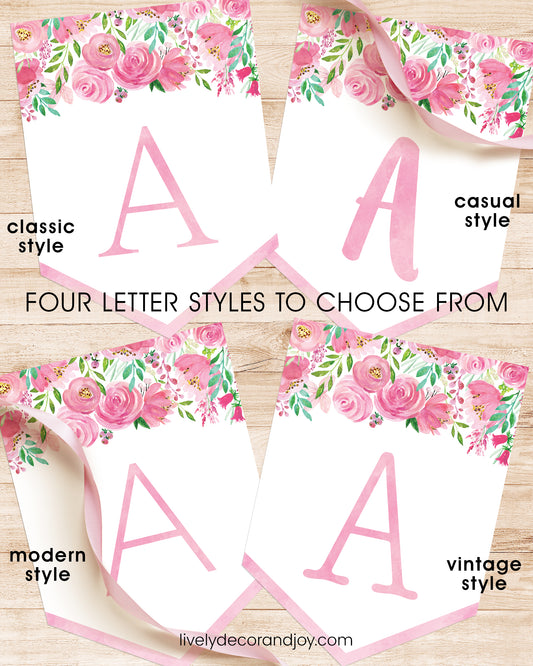 On a wooden table, four banner flags with the same pink floral designs show font styles to choose from. All letters in pink.