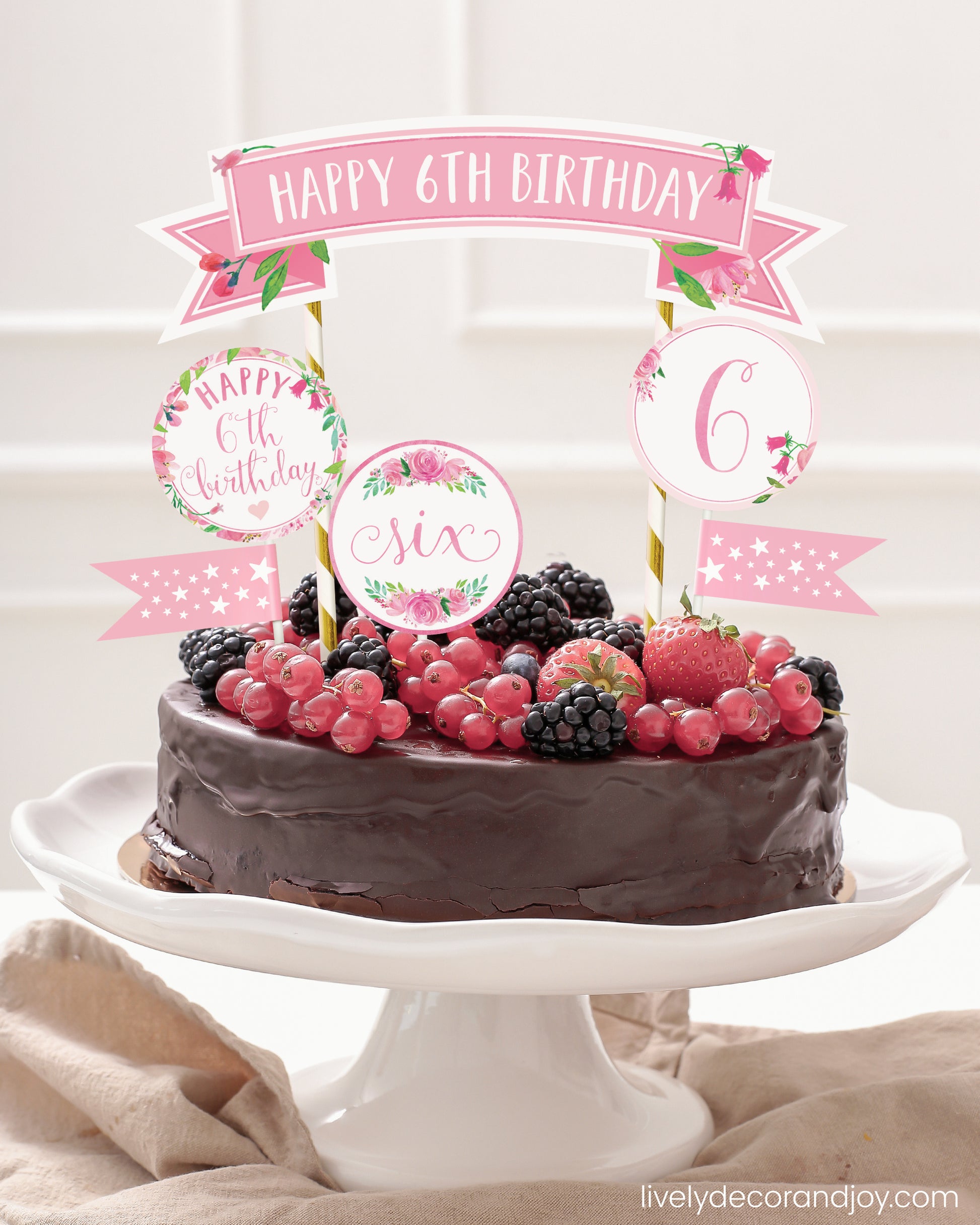 Easy chocolate birthday cake topper made of printable party ribbon and label designs.
