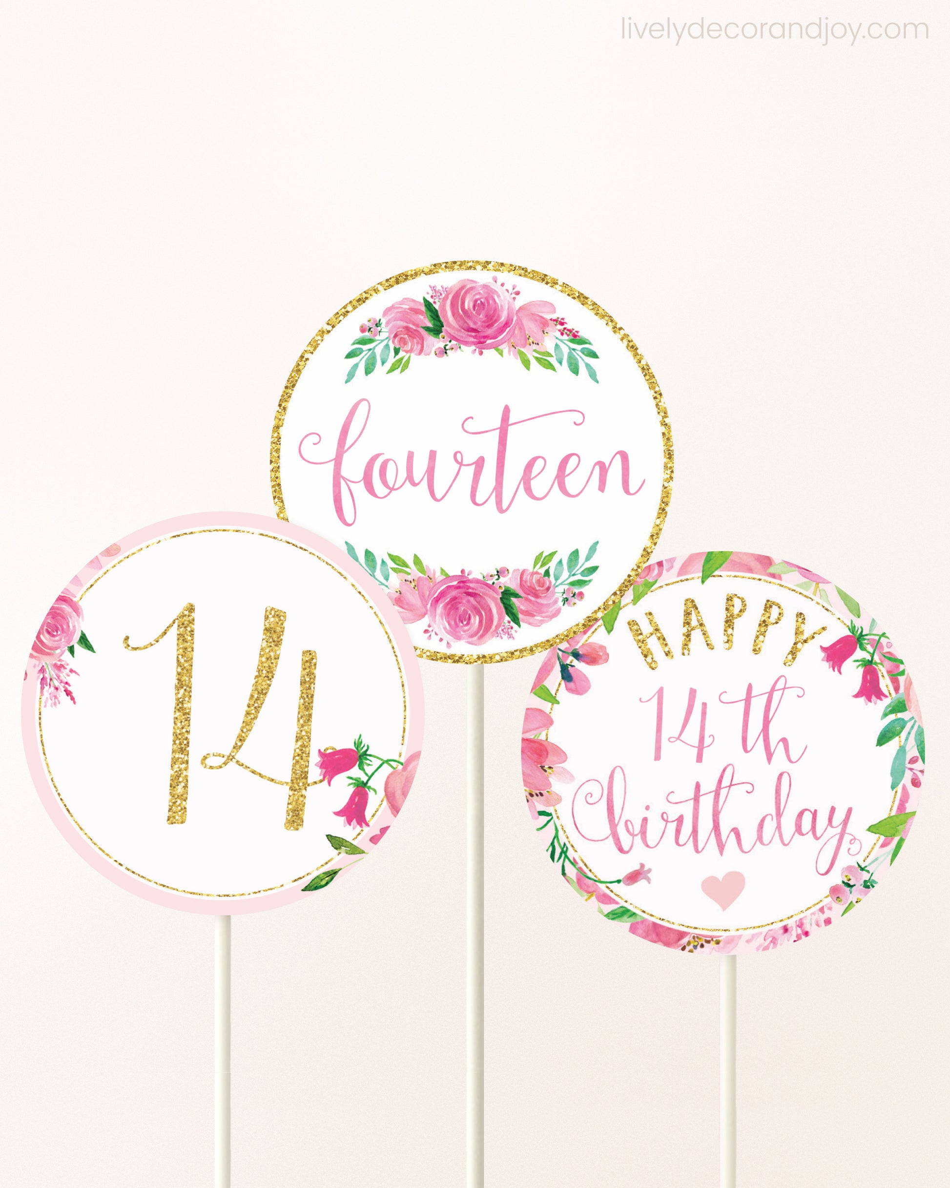 Three DIY toppers attached to lollipop sticks. They show printable cupcake topper designs with pink watercolor flowers.