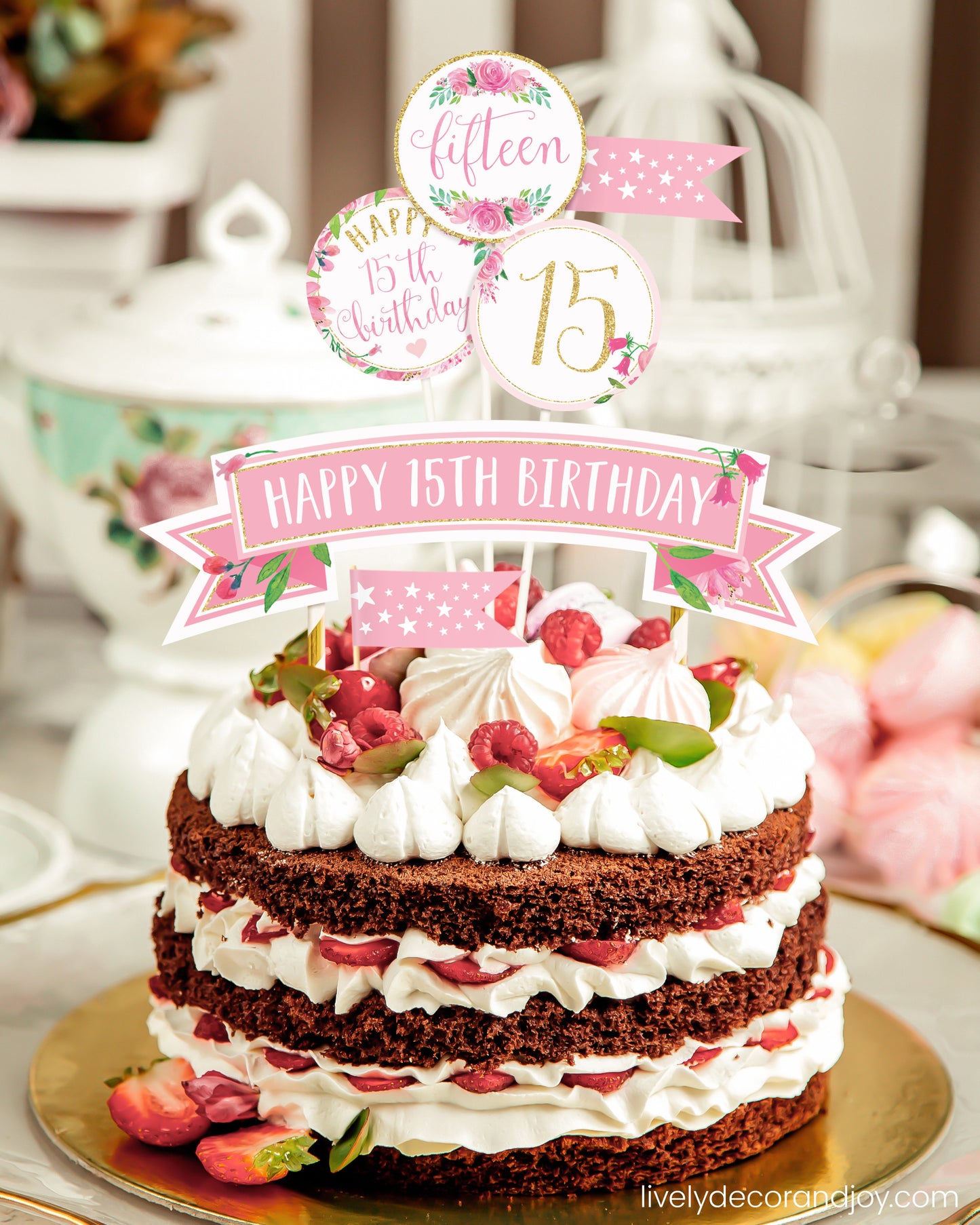 A homemade chocolate cake or strawberry cake with a unique printed cake topper made of floral watercolor designs.