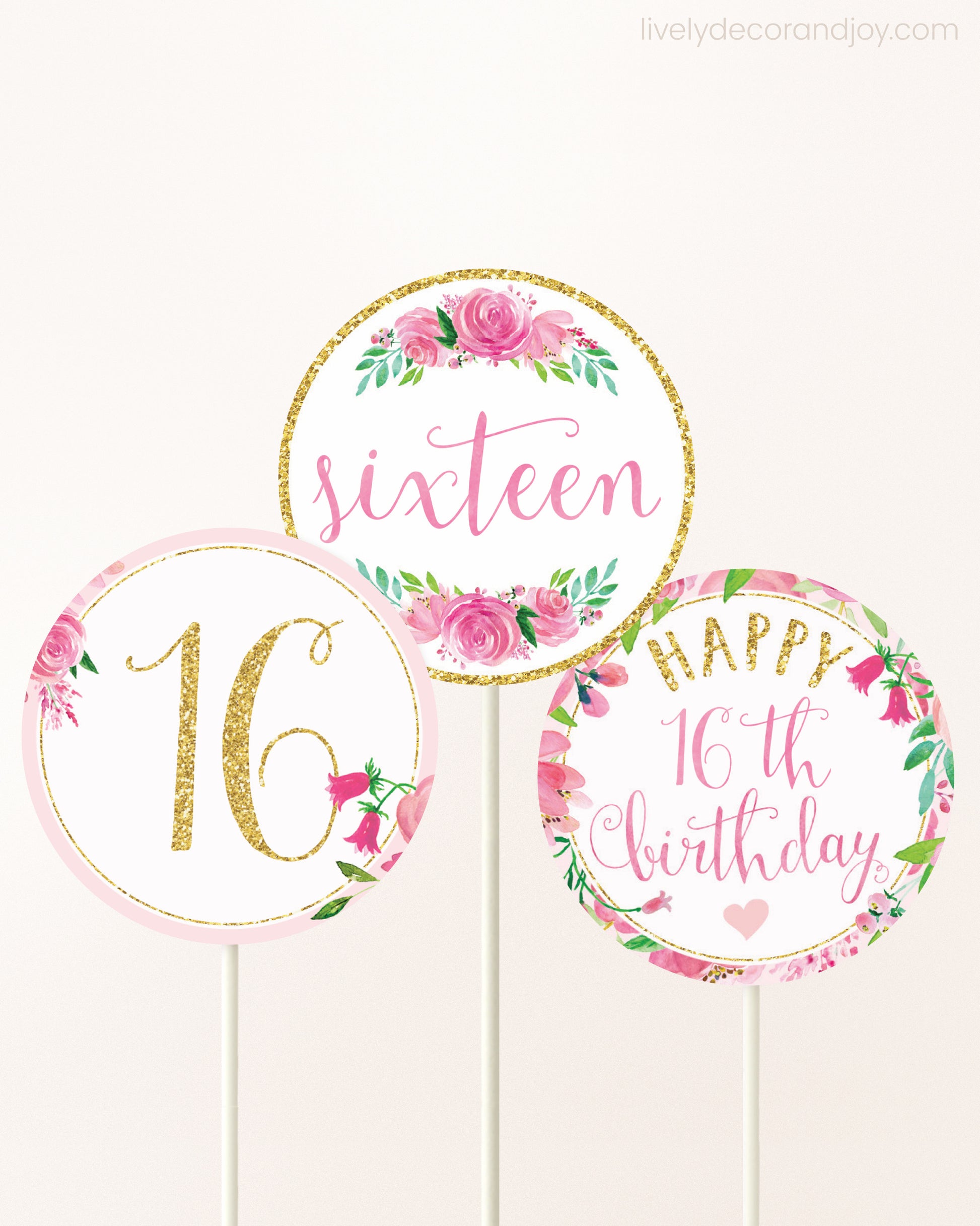 Three DIY toppers attached to lollipop sticks. They show printable cupcake topper designs with pink watercolor flowers.