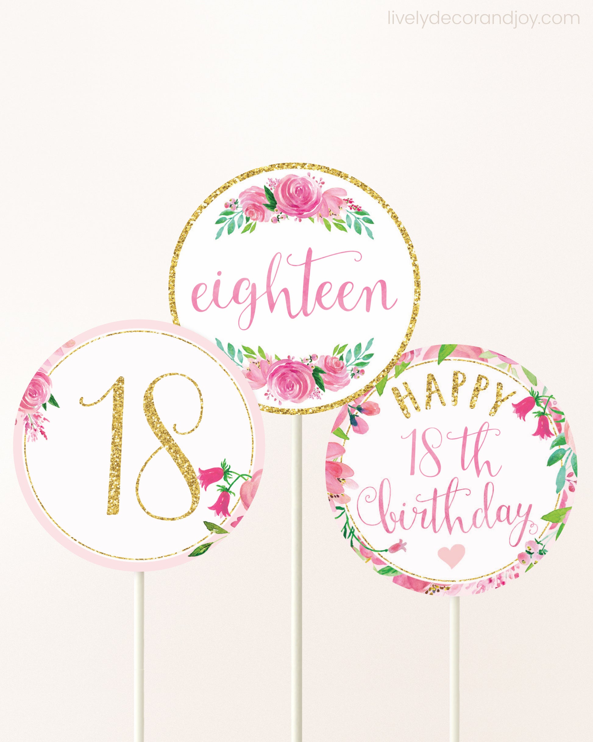 Three DIY toppers attached to lollipop sticks. They show printable cupcake topper designs with pink watercolor flowers.