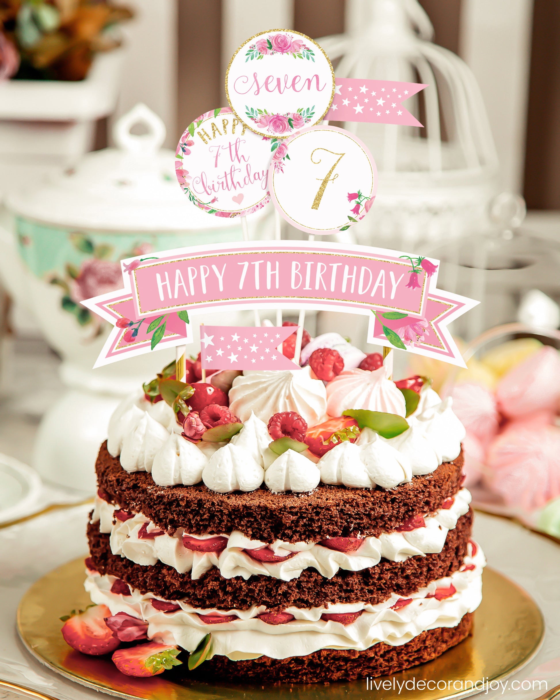 A berry cake or strawberry cake with decorations made of paper from a printable cake topper floral design.