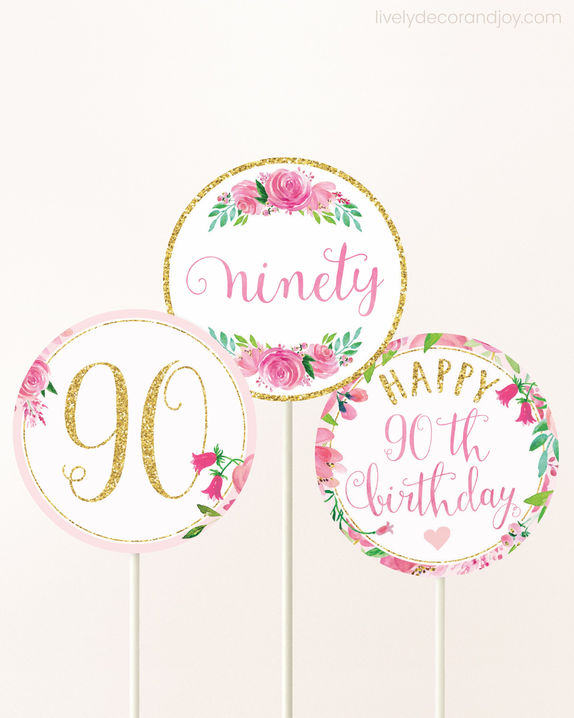 Three DIY toppers attached to lollipop sticks. They show printable cupcake topper designs with pink watercolor flowers.