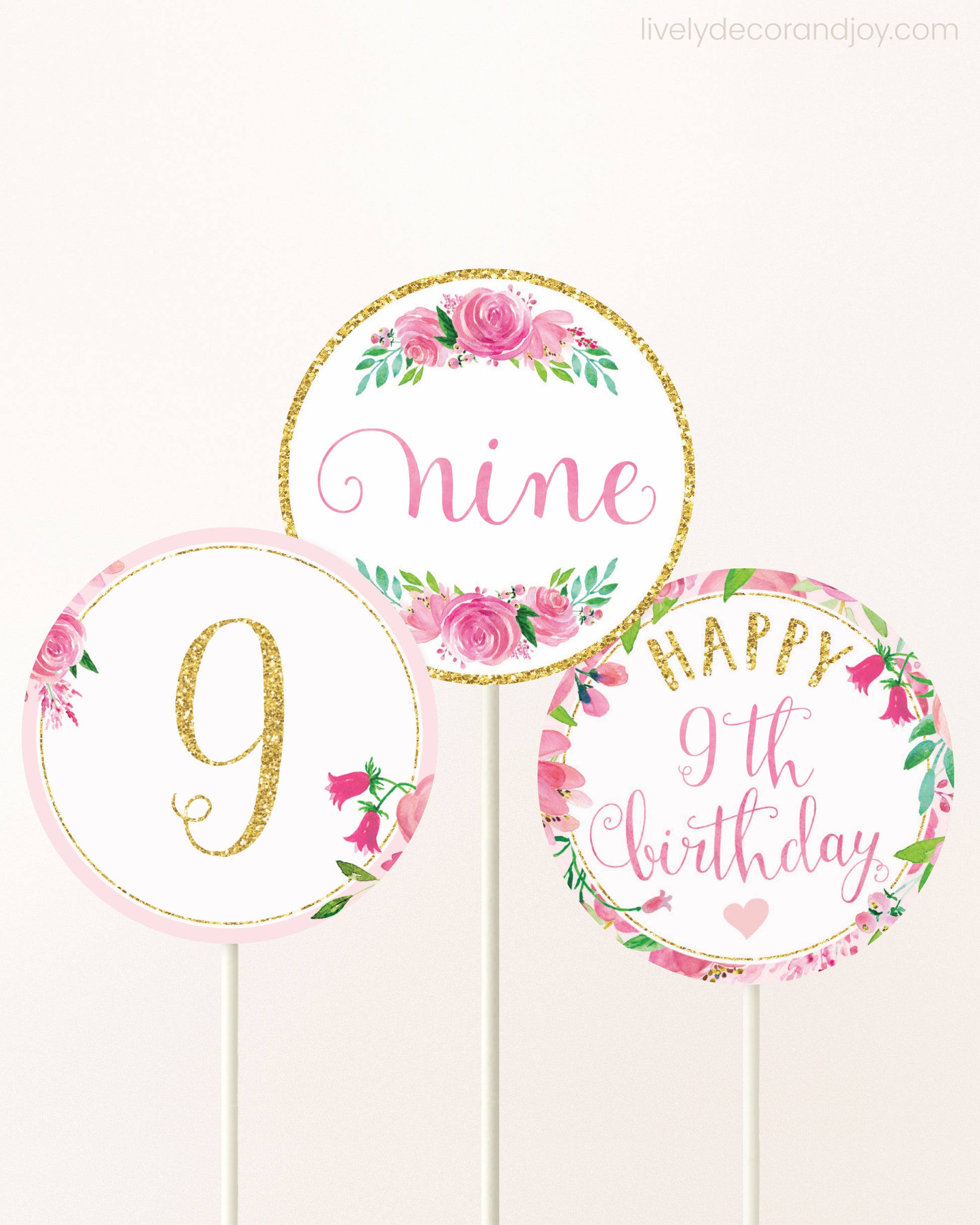 Three DIY toppers attached to lollipop sticks. They show printable cupcake topper designs with pink watercolor flowers.