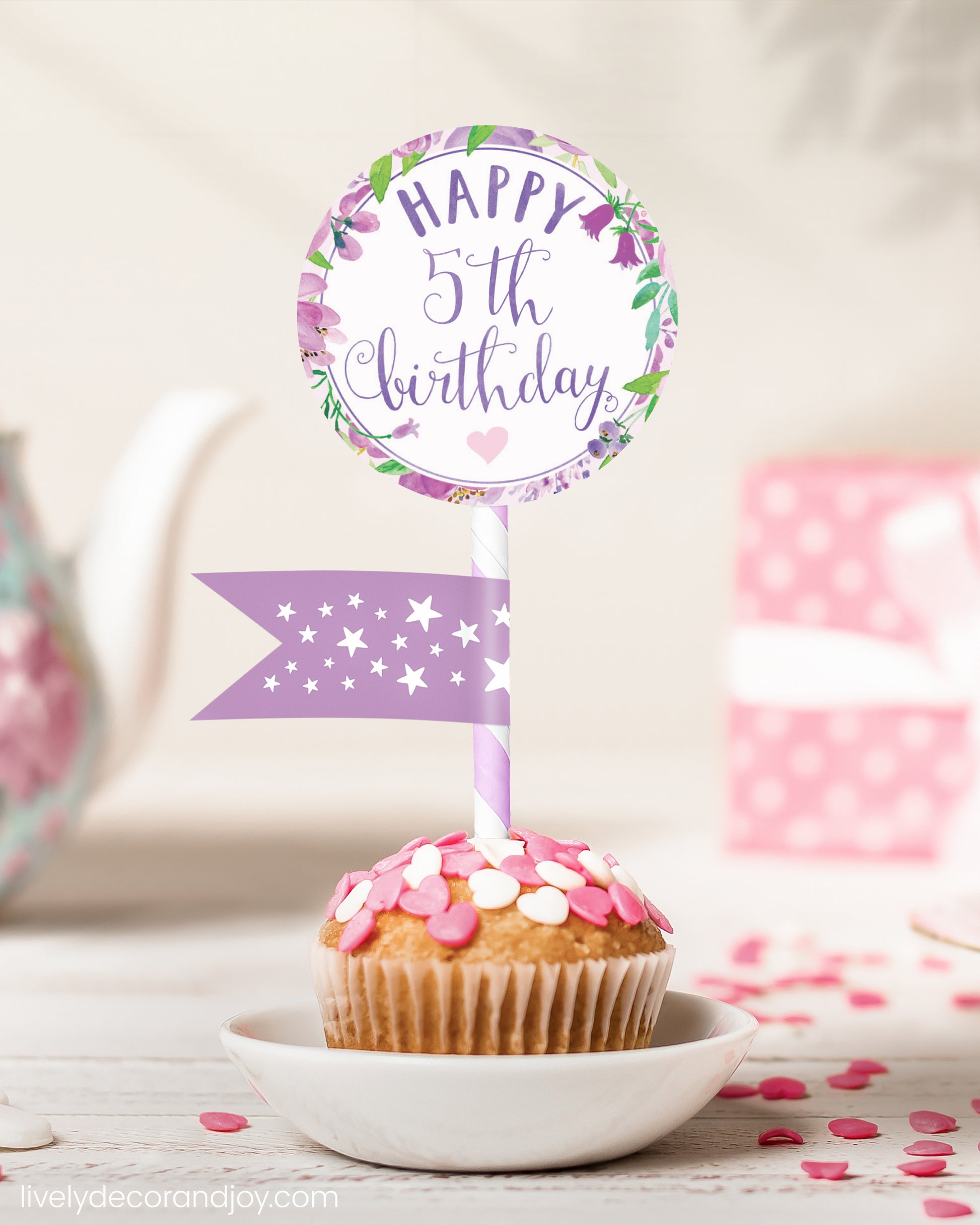 A cute 5th birthday cupcake or muffin topper with a mini flag on a tea-themed party.