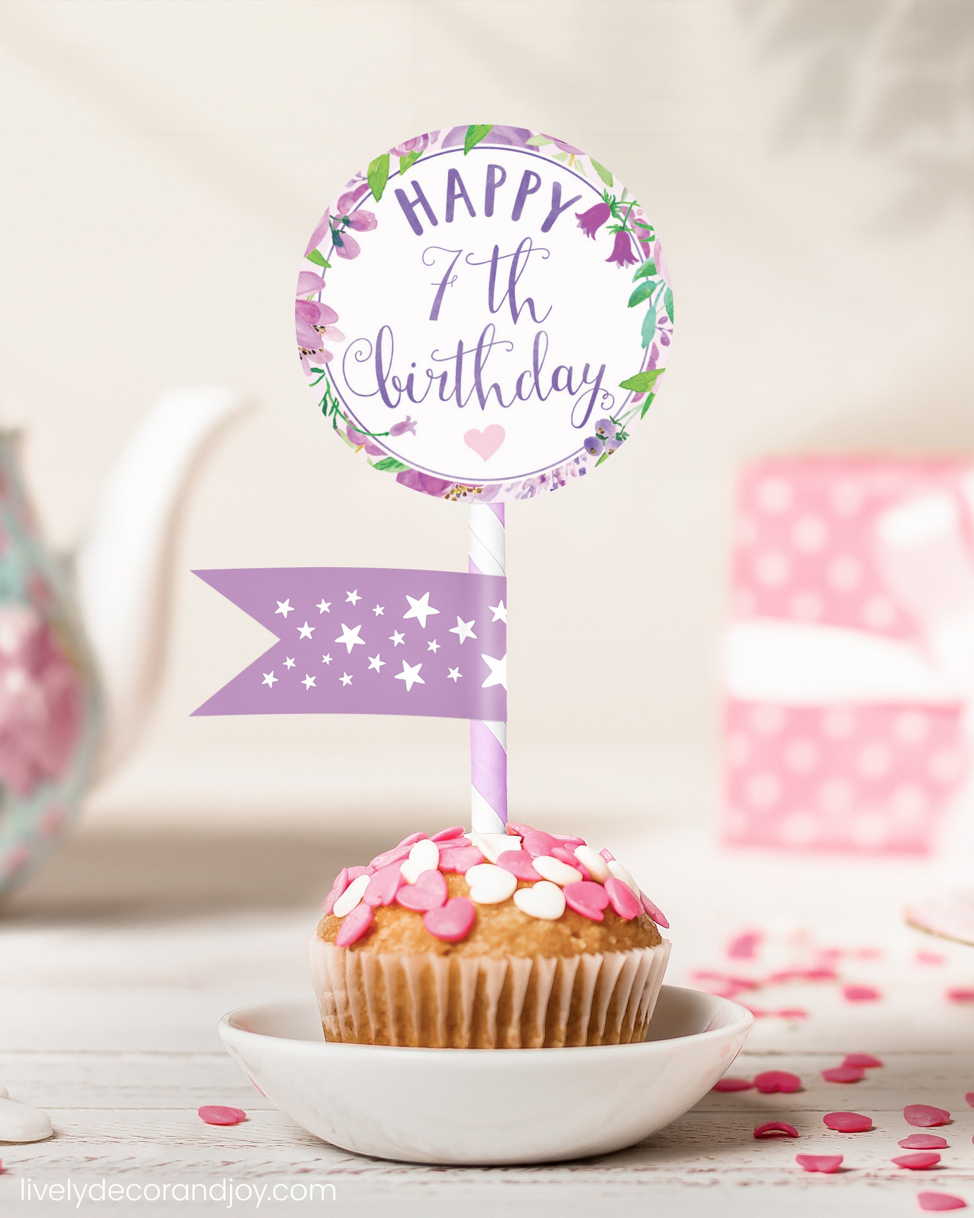 A cute 7th birthday cupcake or muffin topper with a mini flag on a tea-themed party.