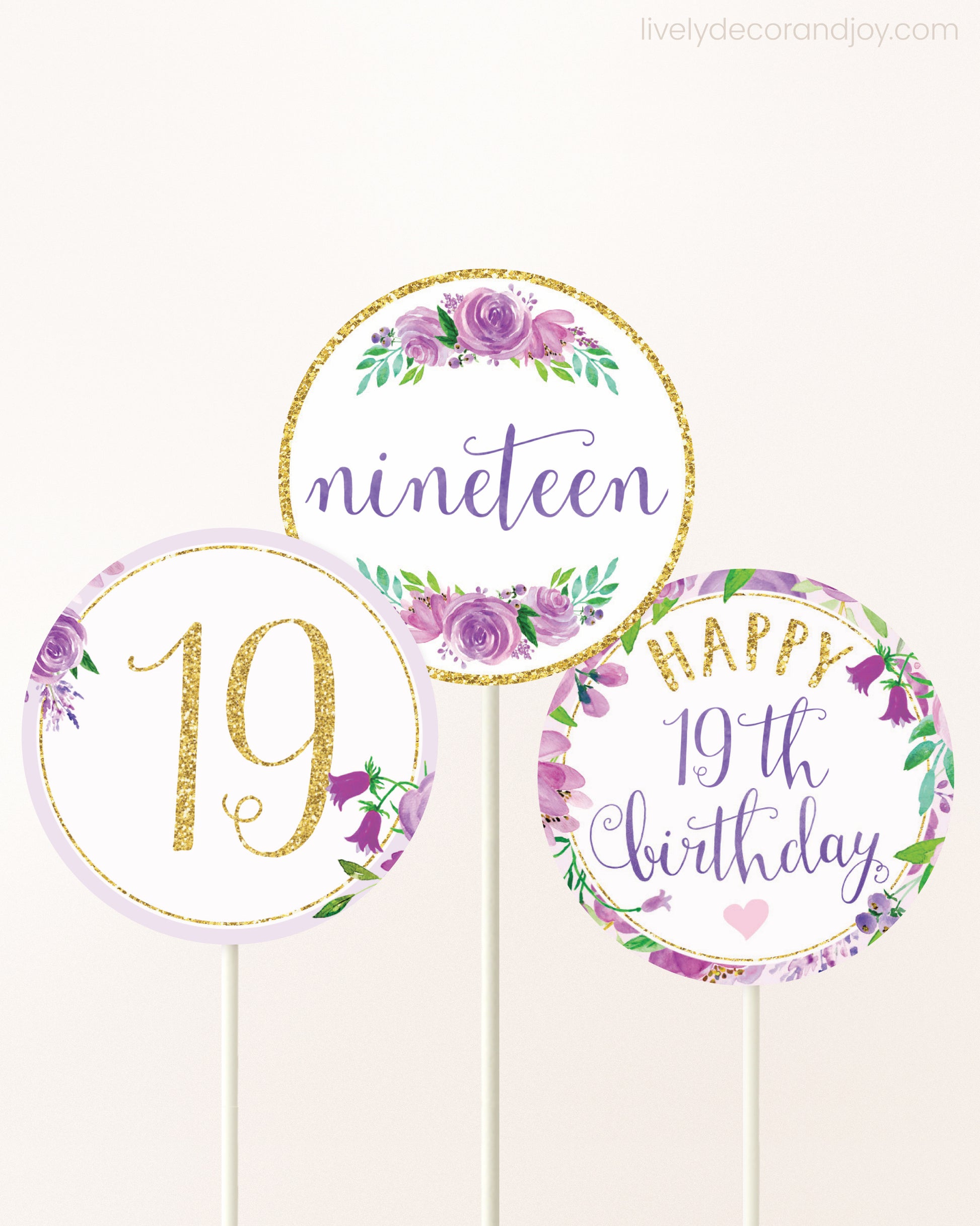 Three DIY toppers attached to lollipop sticks. They show printable cupcake topper designs with purple watercolor flowers.