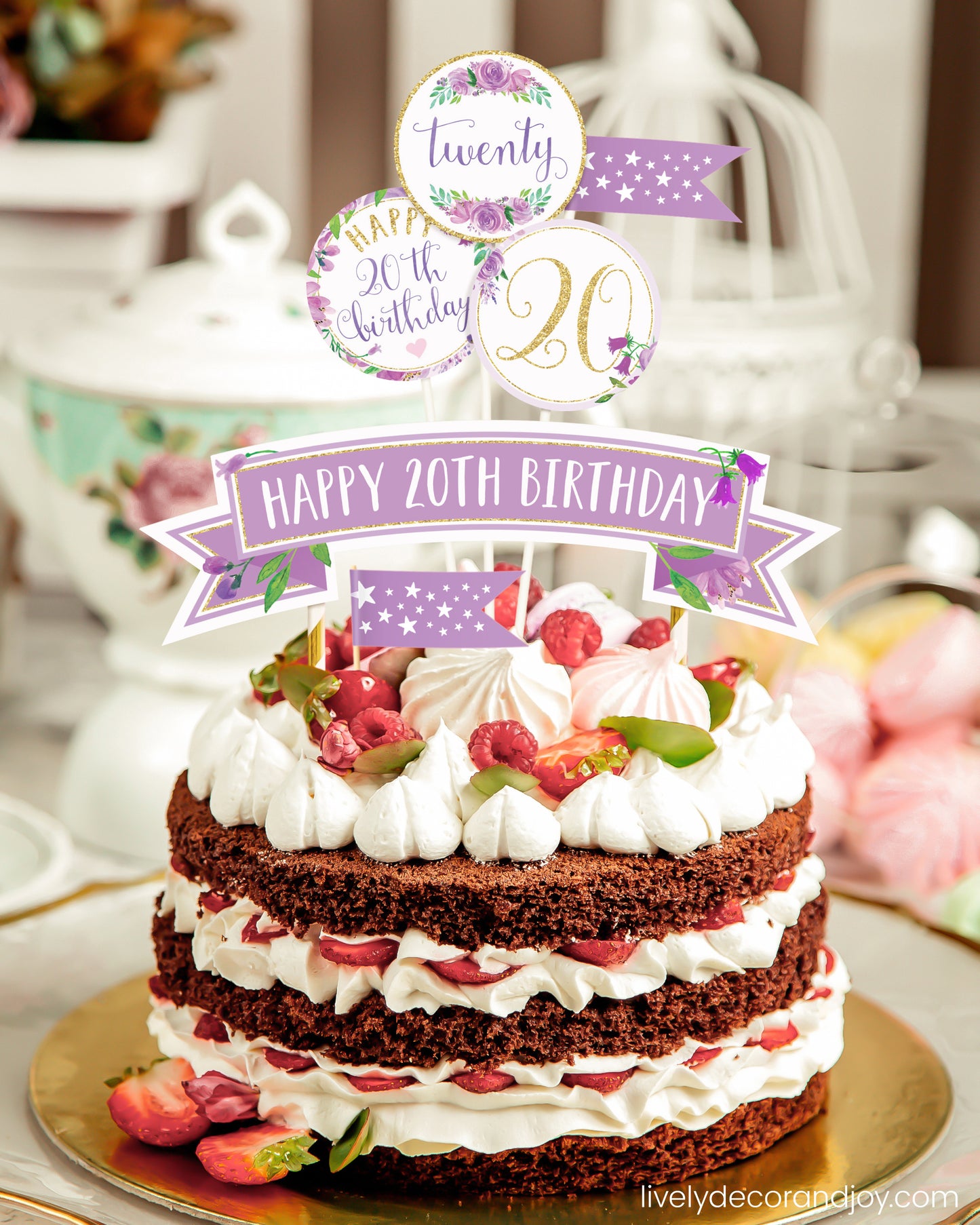 A homemade chocolate cake or strawberry cake with a unique printed cake topper made of floral watercolor designs.