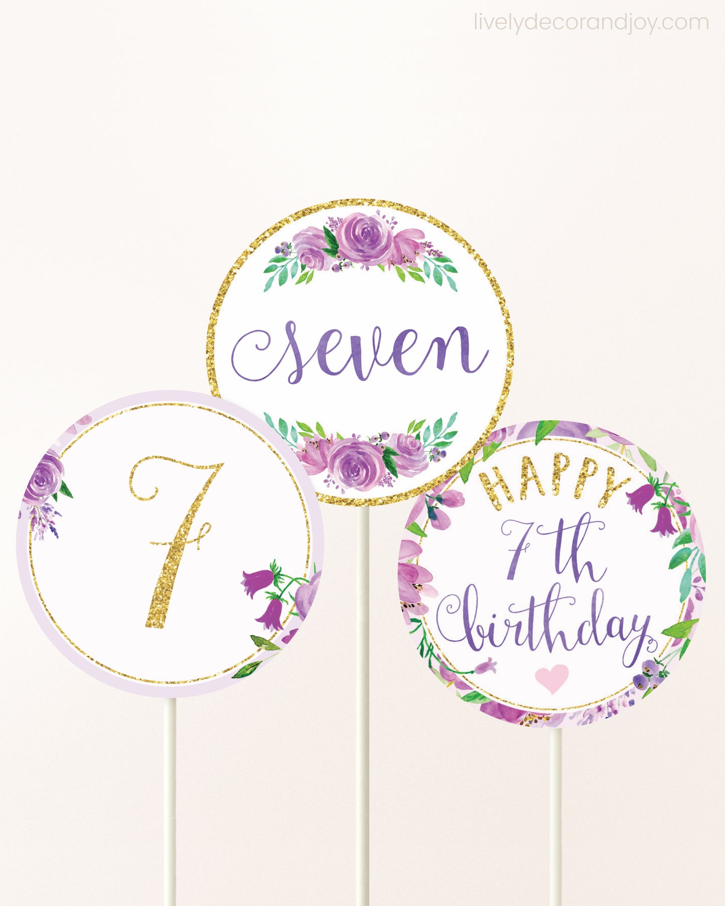 Three DIY toppers attached to lollipop sticks. They show printable cupcake topper designs with purple watercolor flowers.