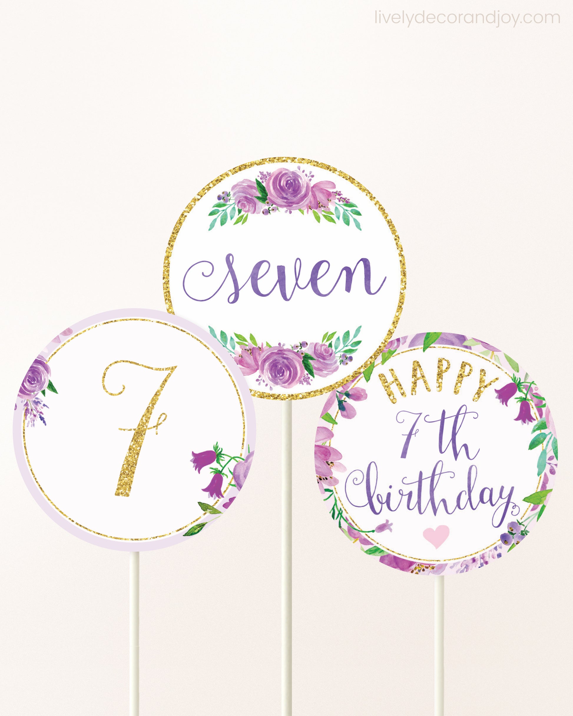 Three DIY toppers attached to lollipop sticks. They show printable cupcake topper designs with purple watercolor flowers.