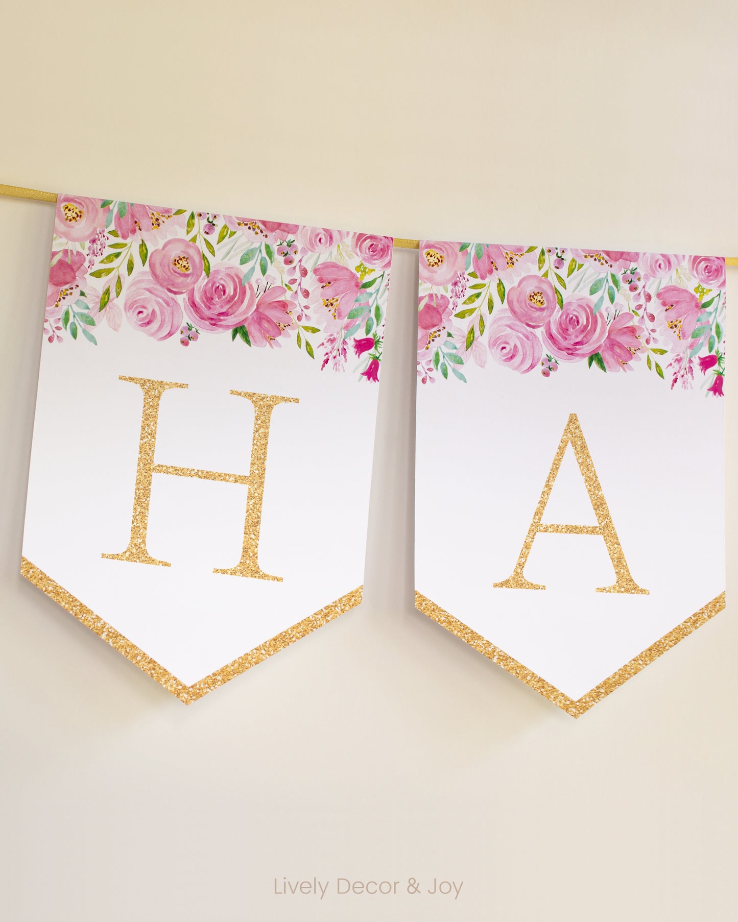 Banner flags on a wall: a Happy Birthday banner or Happy Retirement banner. They have floral designs and letters in gold.