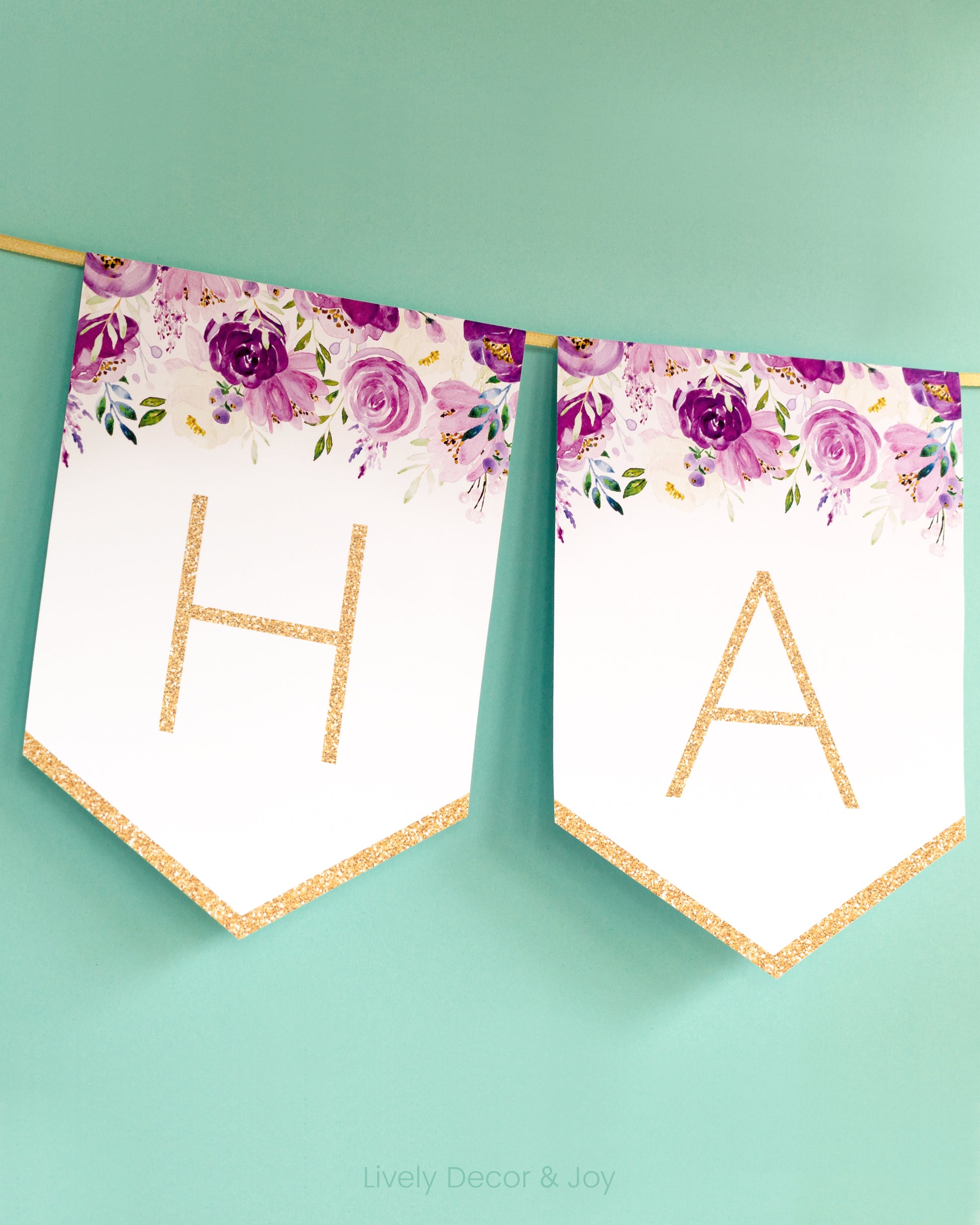 Modern banner flags on a wall with thin letters in gold: a floral Happy Retirement banner or baby shower banner.